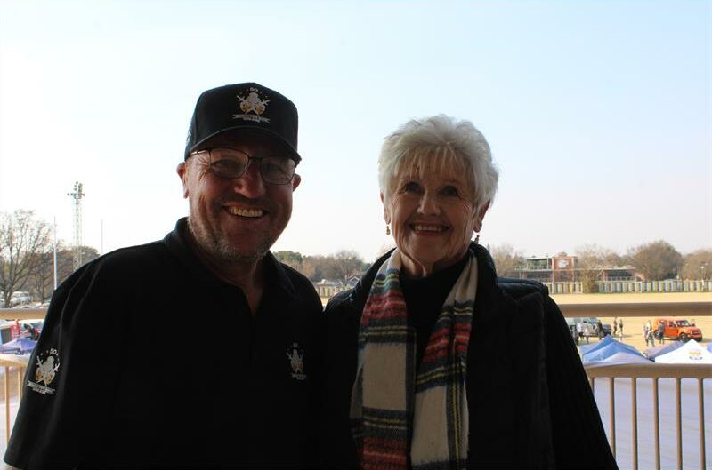 Man wearing a cap standing with an elderly woman