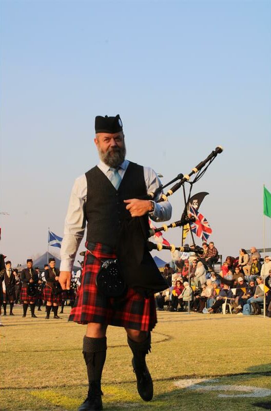 Man with a beard holding bag pipes