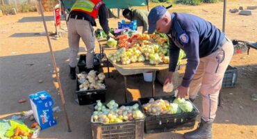 Uniformed officers at a fruit and vegetable stand