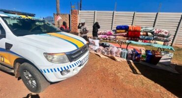 EMPD vehicle parked next to a road side trader displaying blankets