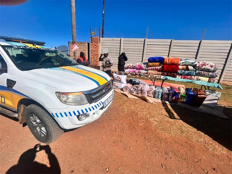 EMPD vehicle parked next to a road side trader displaying blankets
