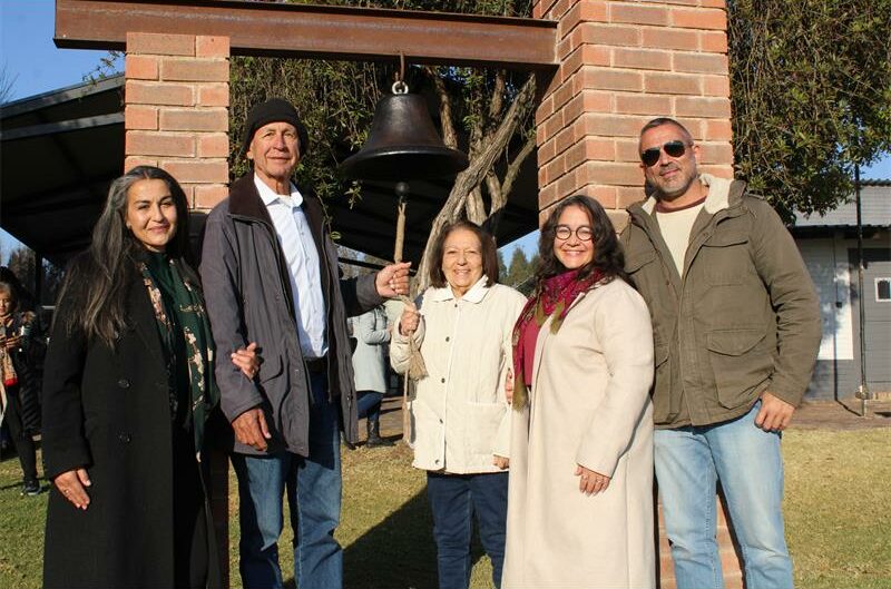 Group of people standing at a bell
