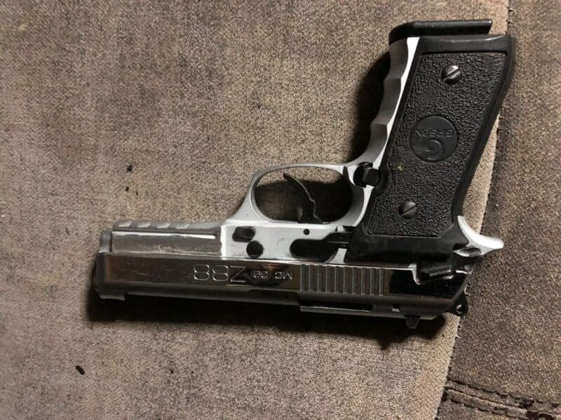 A pistol photographed on a table.