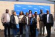 Group of people standing in front of a blue Eskom banner