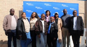 Group of people standing in front of a blue Eskom banner