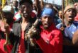 Close-up of two black men who are part of a protest movement, chanting