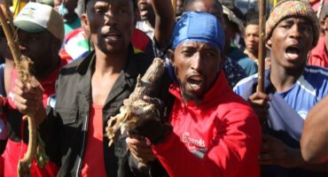 Close-up of two black men who are part of a protest movement, chanting