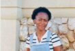 Young black woman standing in front of a wall