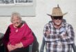 Elderly man and woman sitting in the sun