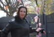 Woman posing next to a flower garland