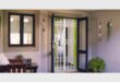 A view of double glass doors taken from inside showing a security gate protecting the home.