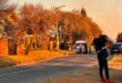 Picture of an ambulance and emergency personnel standing in the road