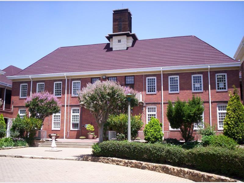 A front view of Willowmoore High School with gardens in the foreground.