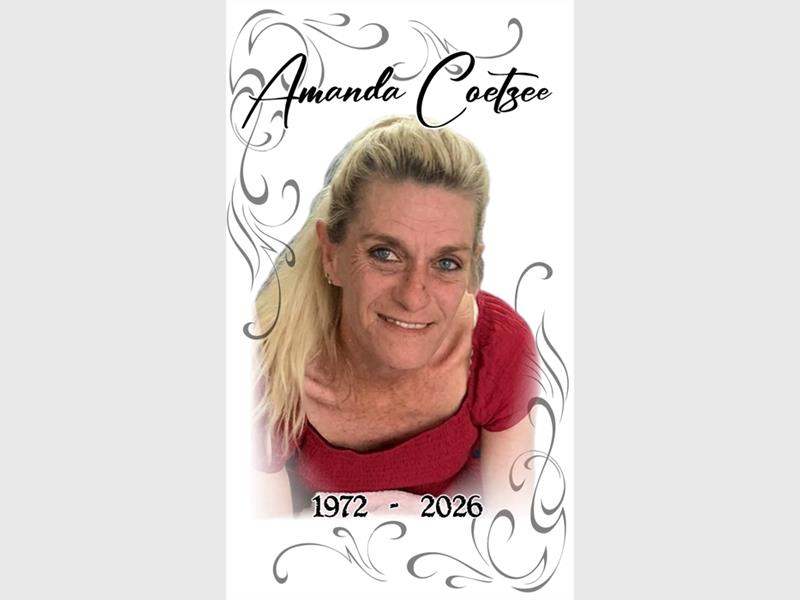 A blonde woman dressed in a red dress taken from above with the words Amanda Coetzee above her head.