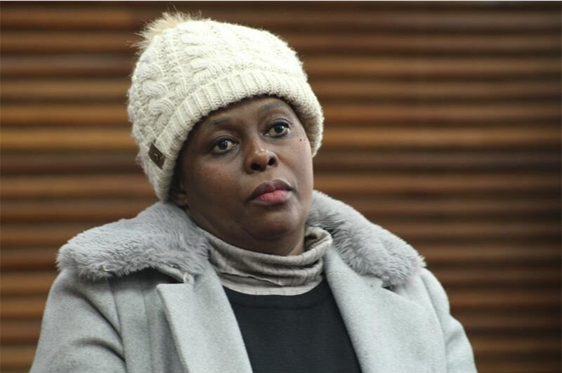 a woman wearing a jacket and hat