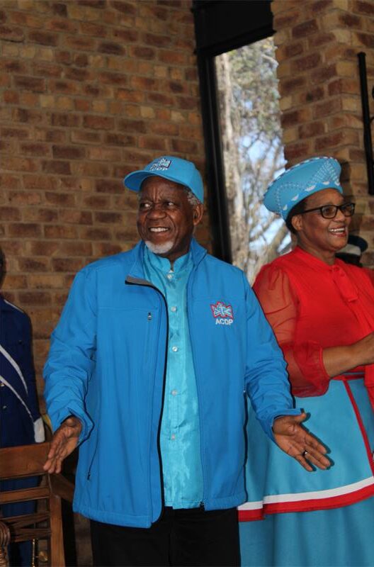 Black man and woman wearing ADCP regalia smiling