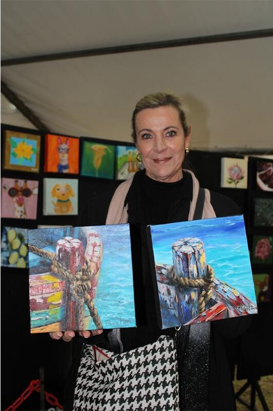 Woman holding two canvasses
