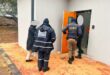 Three people two of which are wearing EMPD uniforms walking into a door