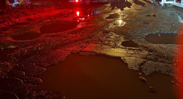 Accident scene with the focus being water filled potholes