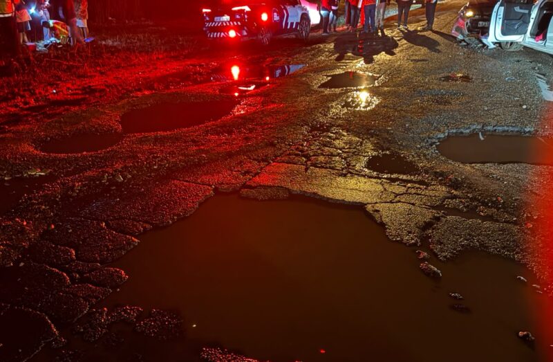 Accident scene with the focus being water filled potholes