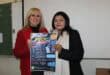Two women holding a poster