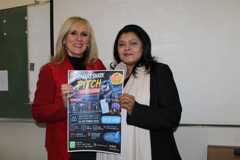 Two women holding a poster