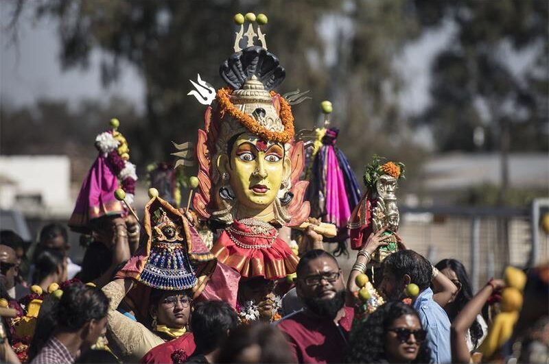 Group of Indian people carrying a deity
