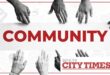 A black and white and red image of hands of various shades reaching in towards each other and the word community.