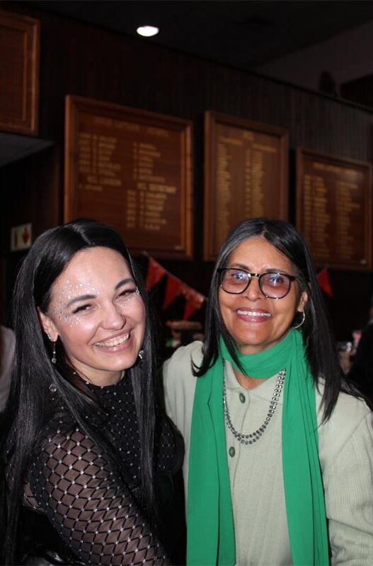 Two women smile as they dance
