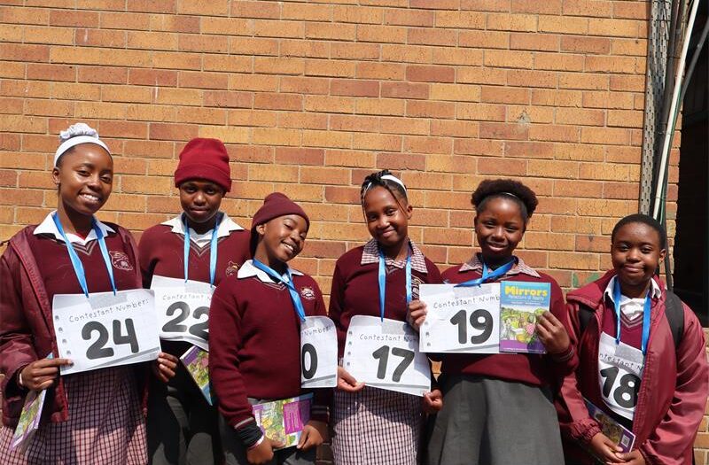 learners wearing burgundy uniform standing next to each other