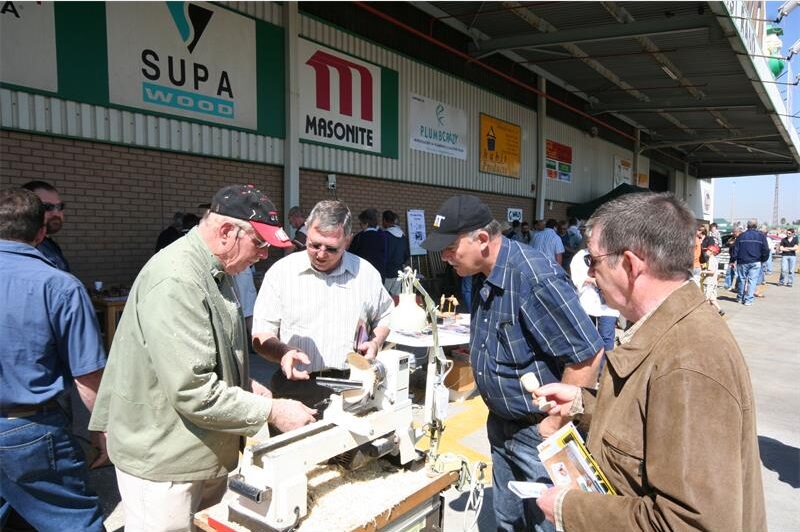 Group of men gathered around a demonstration tool