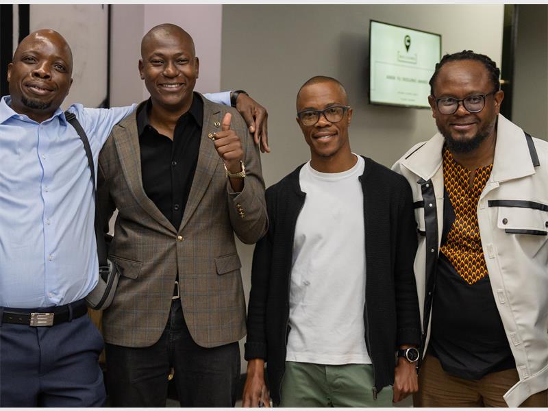 Four black males standing next to each other.
