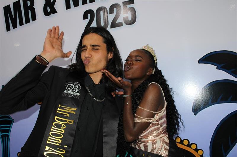Indian man an black lady in formal attire blowing kisses