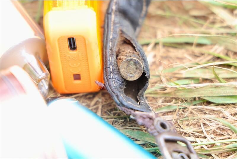 Picture showing the back of a bullet hidden in a strap