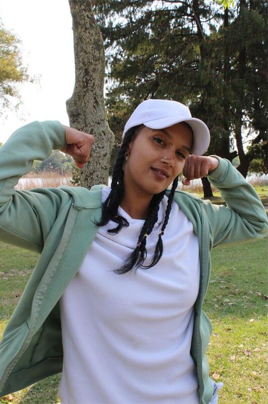 Coloured woman flex her muscles