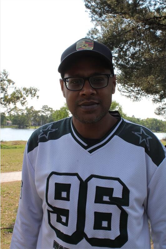 Indian man wearing a cap and sports shirt