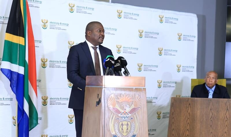 Black man standing at a podium addressing an audience