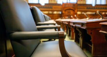 A side view of chairs inside a council chamber.