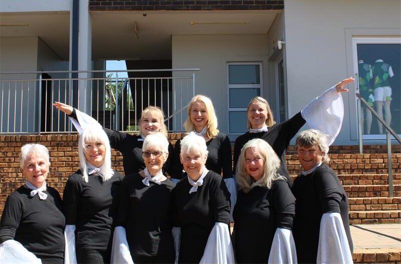 Group of women wearing matching black outfits