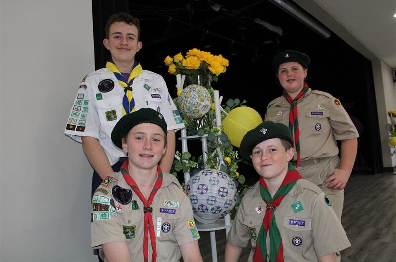 Four kids dressed in scout uniforms