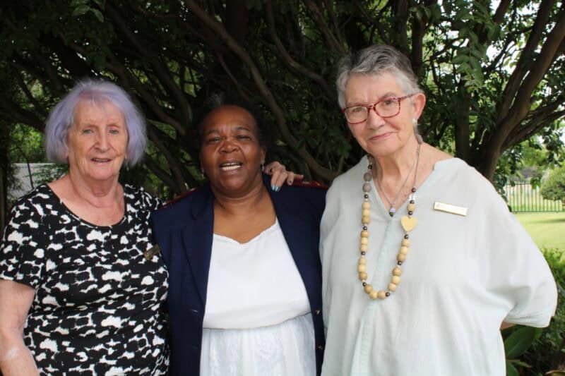 Three women embracing each other