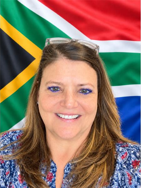 White woman with a South African flag in the back ground