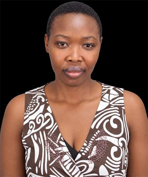 Black woman wearing a white and brown dress