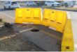 Yellow plastic cordons around a hole in the ground