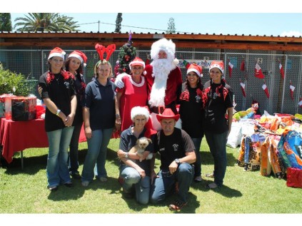 The SPCA received numerous donations of pet food and other goodies, and was transformed into a festive delight, complete with Christmas stockings and a visit from Santa. Seen here are SPCA staff members and committee members.