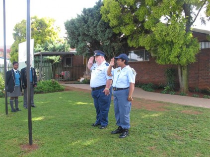 Capt Joep Joubert and Sgt Lucia Govender, from the Brakpan SAPS, were invited to take part in Dalpark Private School's flag-raising ceremony. They are seen in salute in front of the raised flags.