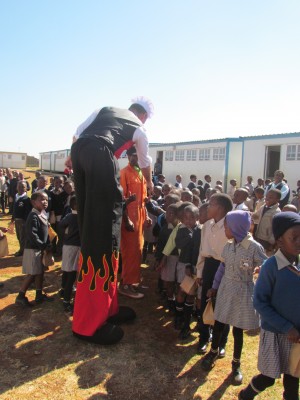 Carnival City’s stilt walker, Ken Lindsay, was in the entourage which visited local schools to hand out soup and chocolates.  