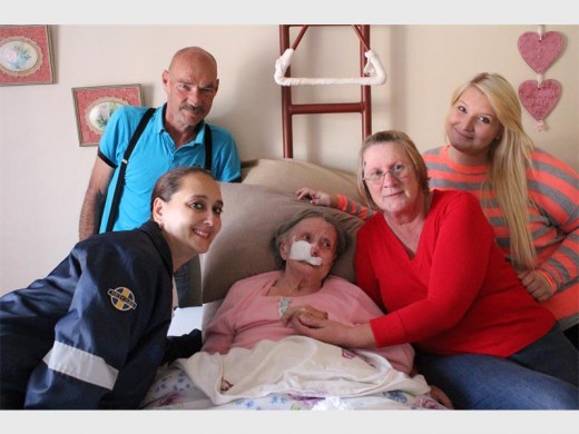 Two days before Magdalena Muller was transported toa hospital in Kroonstad, she was comforted by family and friends. Seen with her are, back (from left): Graham Taylor, her son-in-law, and Stephanie Pearse (Cansa). Front: Santi Steinmann (Netcare) and Mariet Taylor, her daughter.