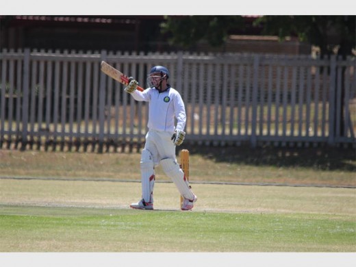 United Cricket Club’s opening batsman, Jose van der Berg raises his bat after reaching a half-century in the match against Boksburg,