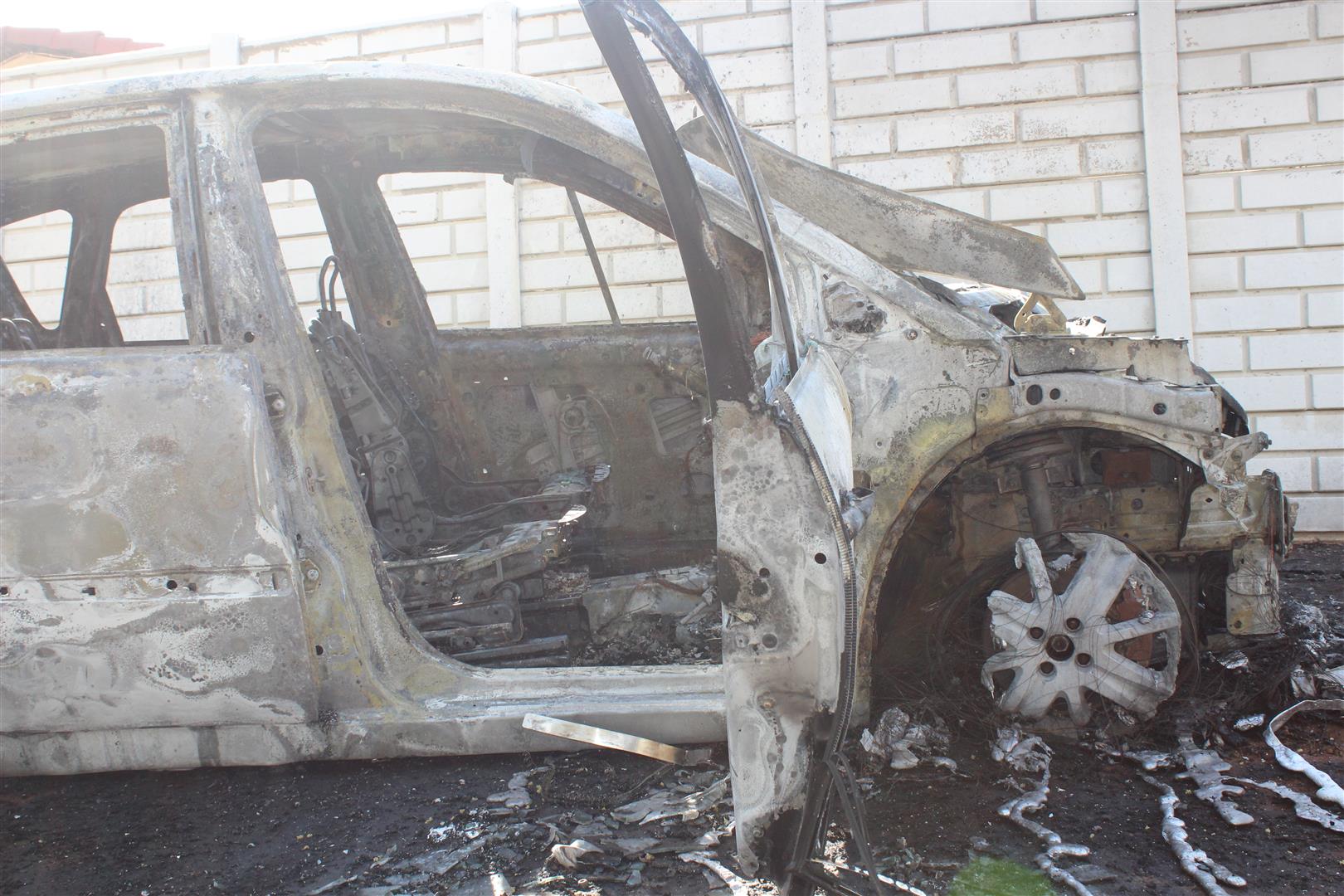 A burnt-out car, believed to be the shooters' vehicle, was found a few streets away.
